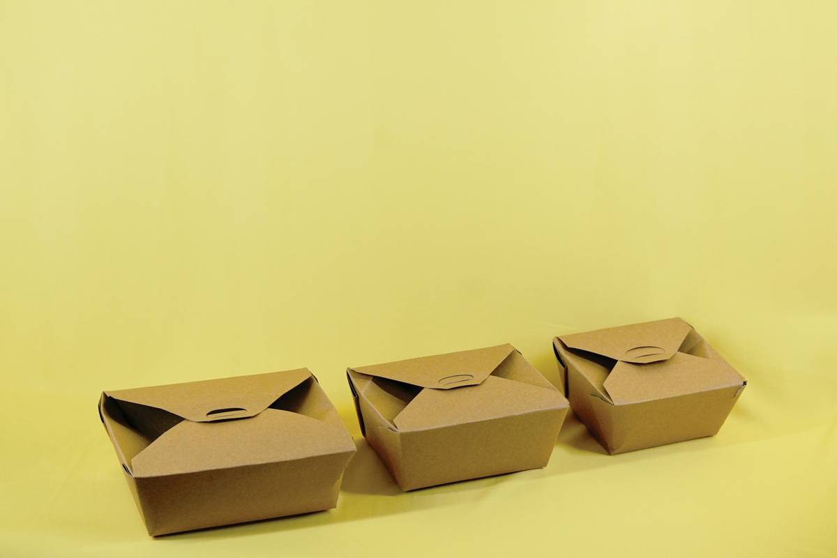 Woman using sustainable food storage methods with silicone bags in modern kitchen