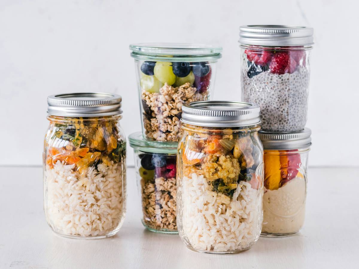 Close-up of eco friendly food storage containers being sealed shut with fresh berries inside