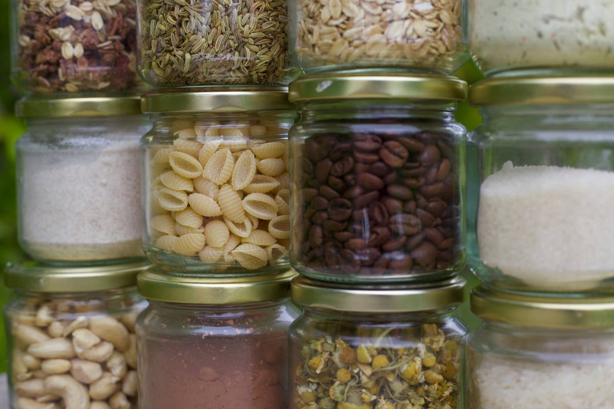 Stacked eco friendly food storage containers made of platinum silicone beside fresh produce