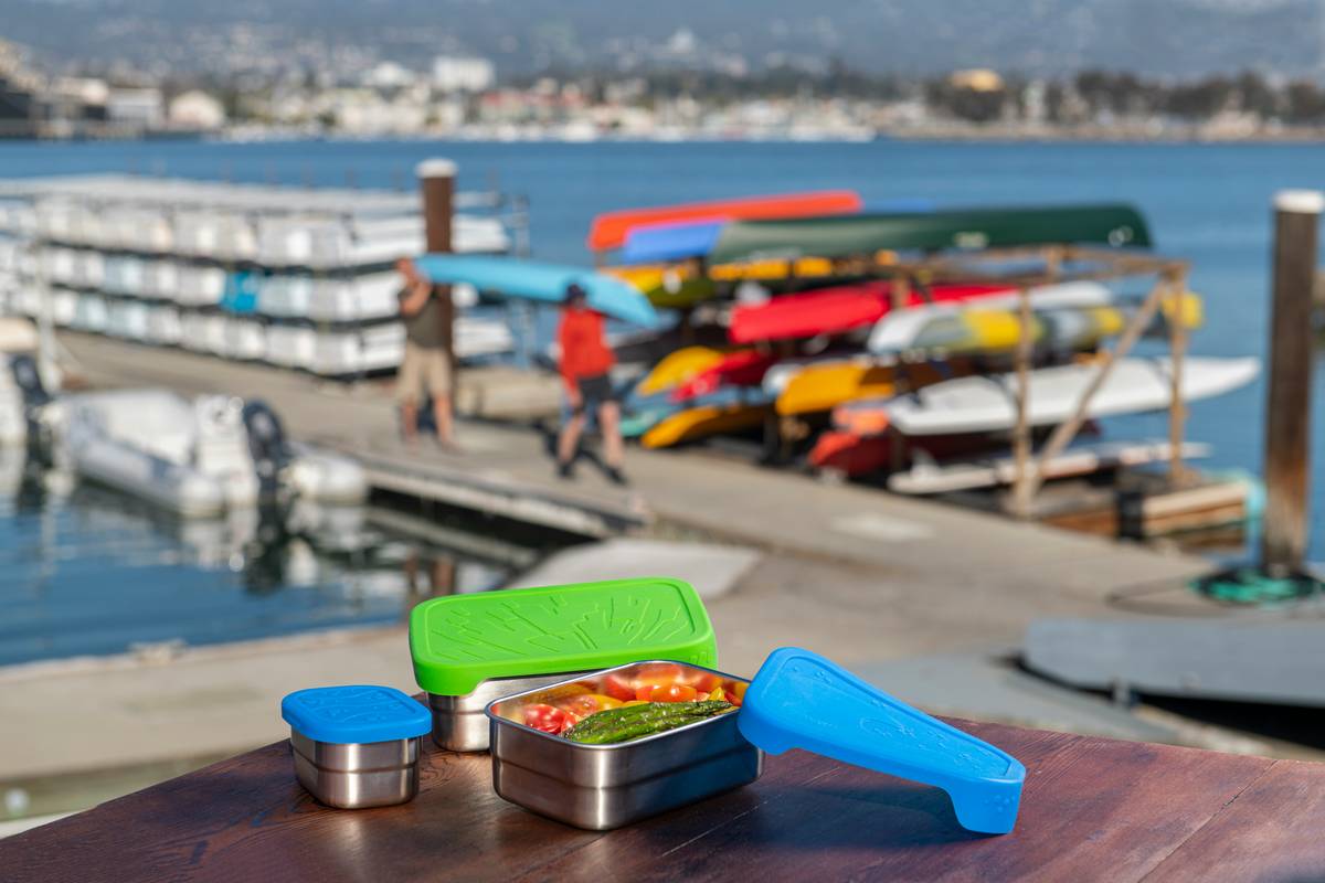 Stackable silicone storage containers for food in various sizes on a clean kitchen counter